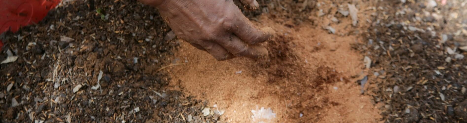 Hands over soil mixing in soil amendments for better soil quality Hands over soil mixing in soil amendments for better soil quality