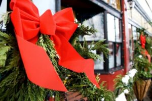 red ribbon on greenery on post