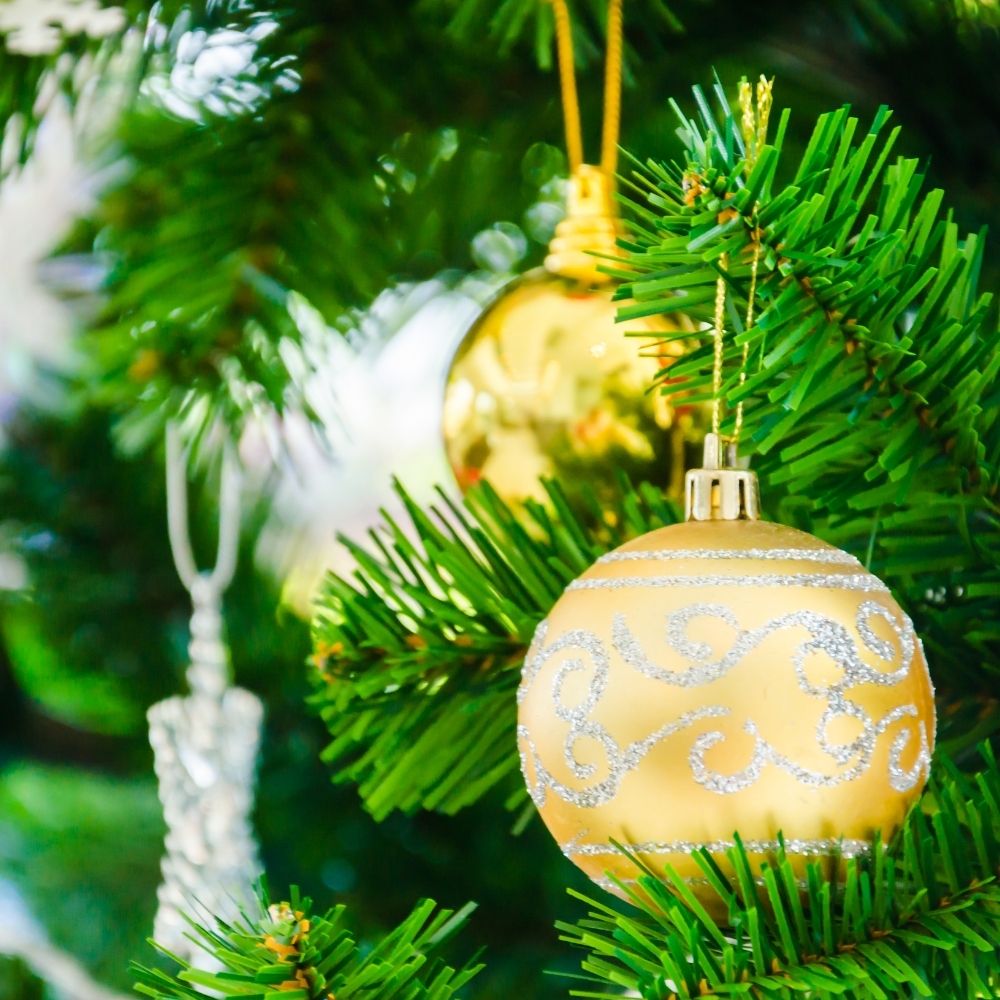 gold ornament on christmas tree gold ornament on christmas tree