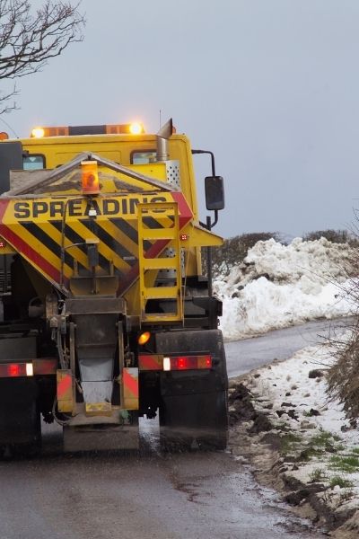 truck spreading salt onto roads salt damage gardens