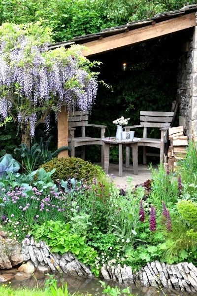 cottage core garden with cottage style plants firewood rustic furniture