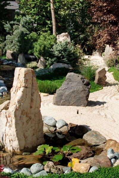 meditative zen garden with boulders sand evergreens