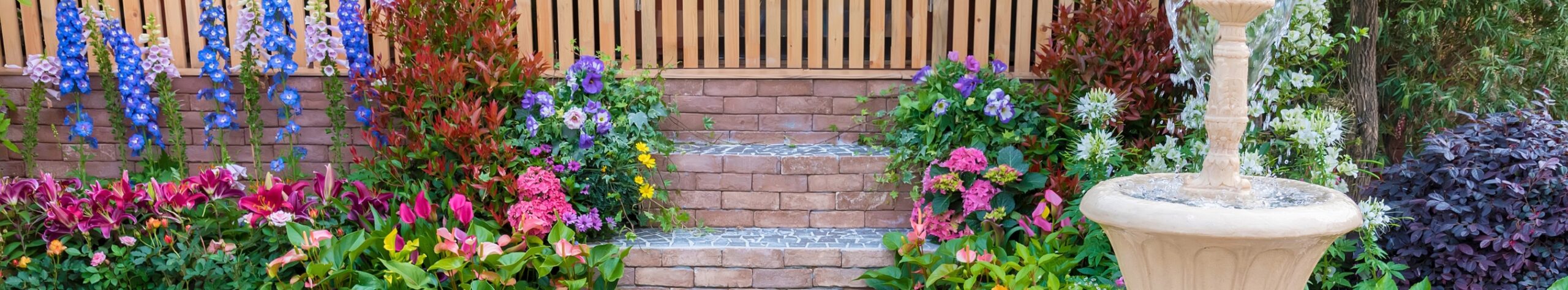 walkway with flowers and a fountain